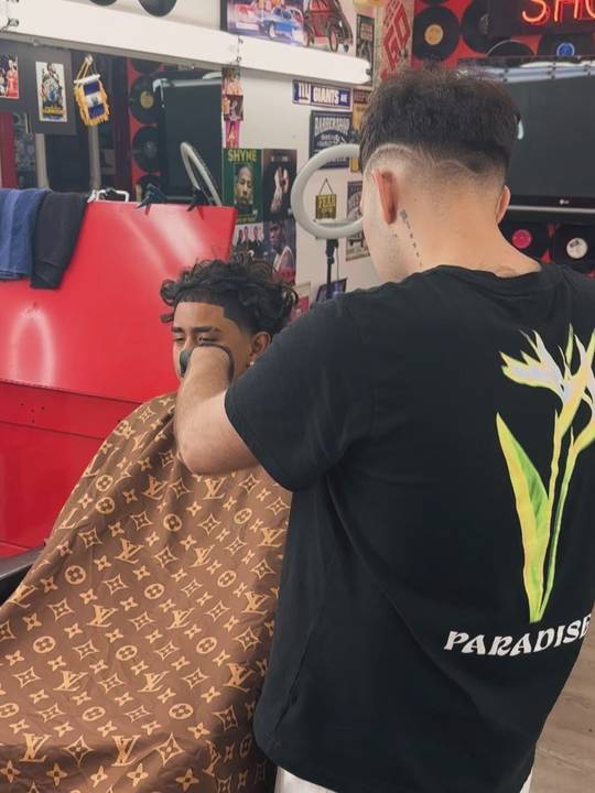 Niko working on a client in the chair
